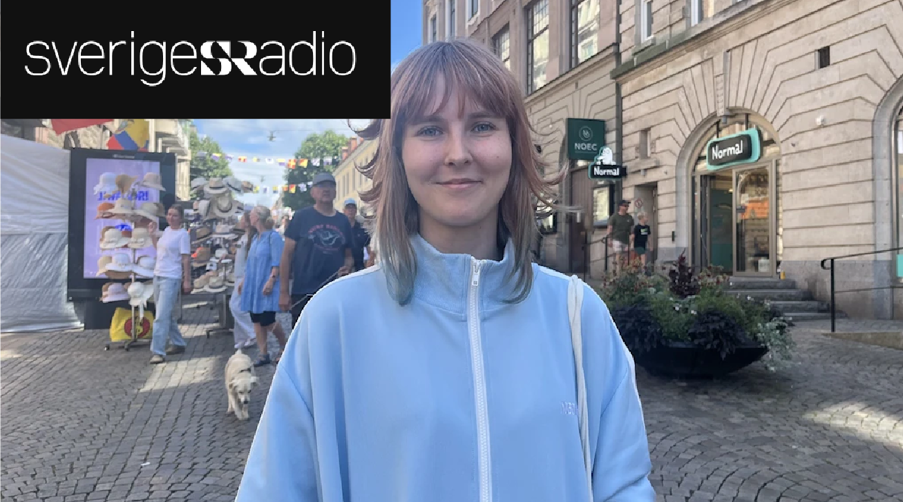 A young woman stands in a Swedish city street